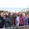 Teachers at the Trinity Center stand on a boardwalk