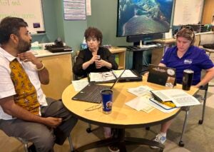 Participants of WAC's summer workshop sit together